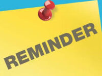a yellow notice tacked to a bulletin board that says "reminder"